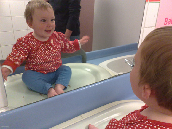 Eilis greeting herself in the mirror