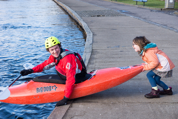 Eilis pushing a kayaker into the water