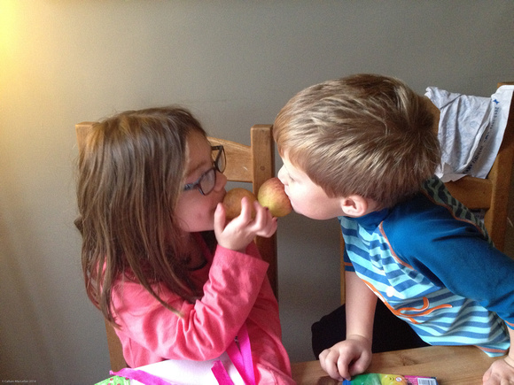 Eilis and Seonaidh playing with apples