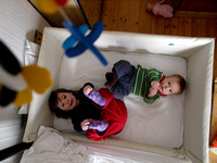 Eilis and Seonaidh play in his cot